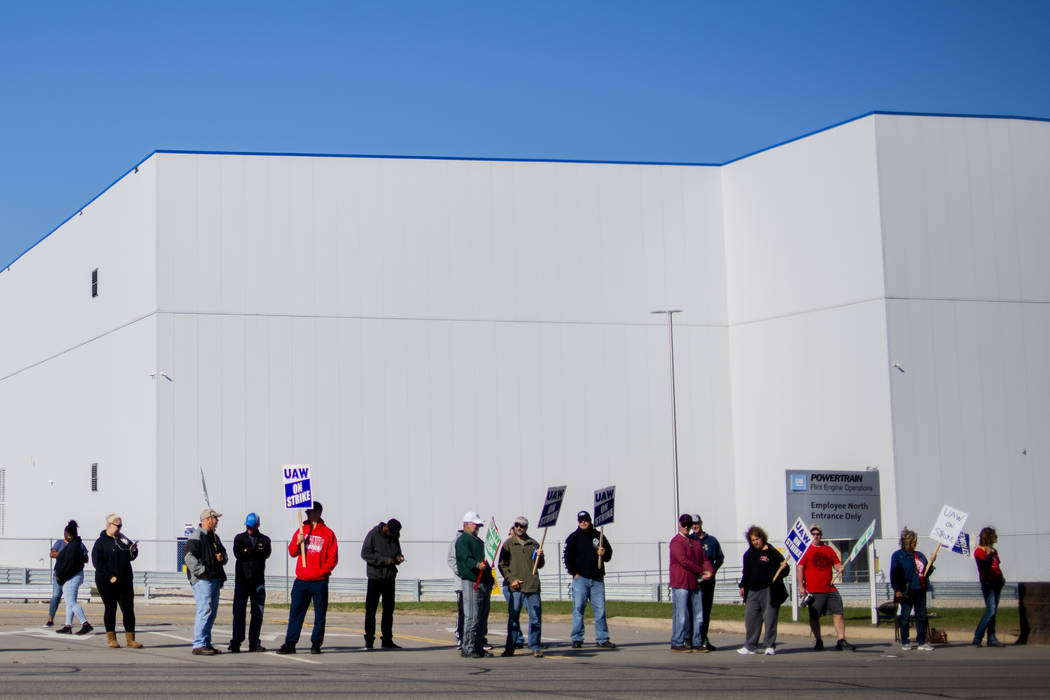 General Motors' Flint Assembly Plant employees line the street with picket signs during the nat ...