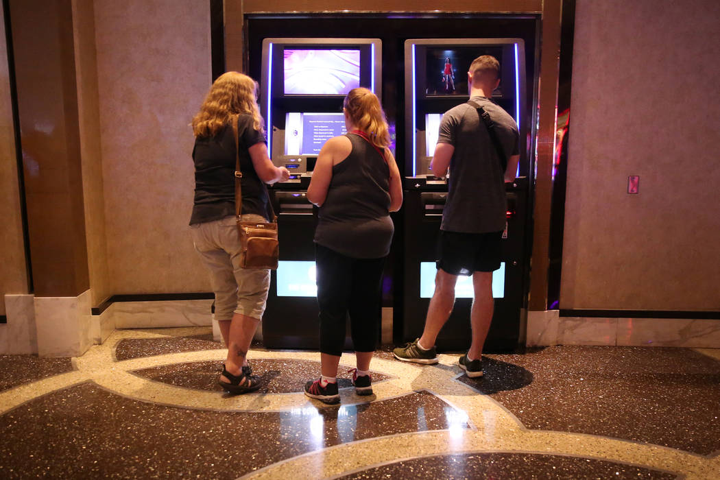 People use redemption kiosks at the Cosmopolitan hotel-casino in Las Vegas, Tuesday, Oct. 8, 20 ...