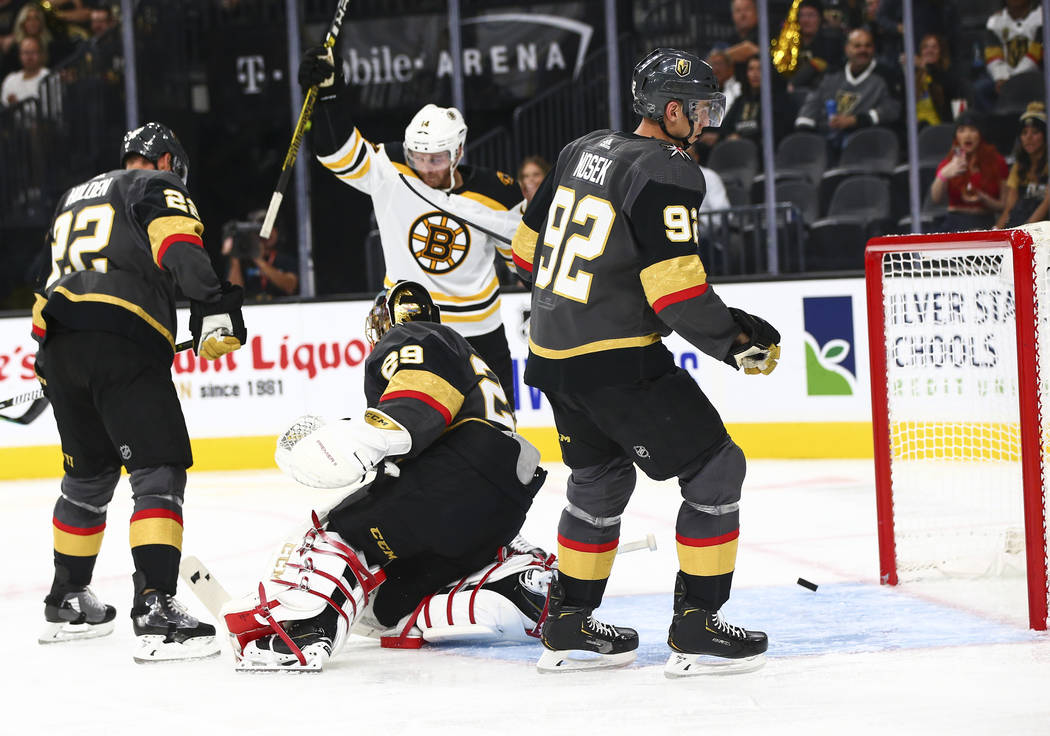 Boston Bruins' Chris Wagner, center, celebrates after his teammate Torey Krug (not in picture) ...