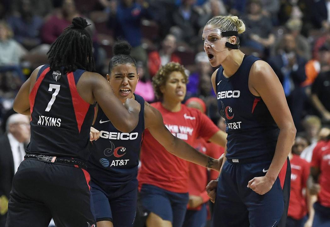 Washington Mystics' Elena Delle Donne, right, celebrates a play with Ariel Atkins, left, and Na ...