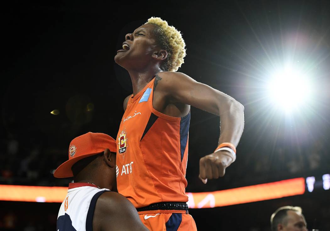 Connecticut Sun's Courtney Williams gets a lift from her father Don Williams after the Sun defe ...