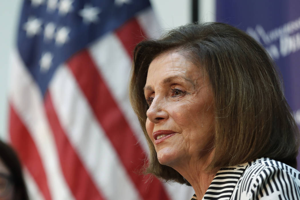 Speaker of the House Nancy Pelosi, D-Calif., listens during a talk about lowering the cost of p ...