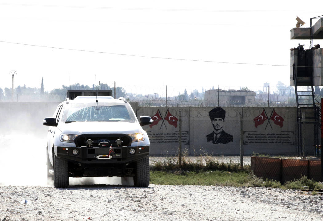 Backdropped by a graffiti of modern Turkey's founder Mustafa Kemal Ataturk on the Turkish side ...