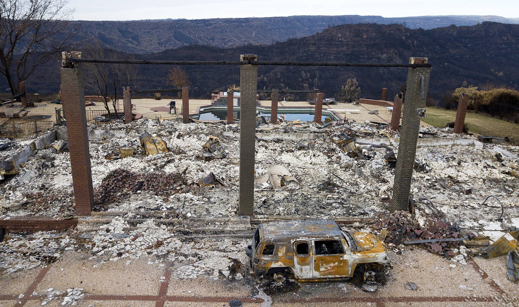 A vehicle rests in front of a home leveled by the Camp Fire in Paradise, Calif., Dec. 3, 2018. ...