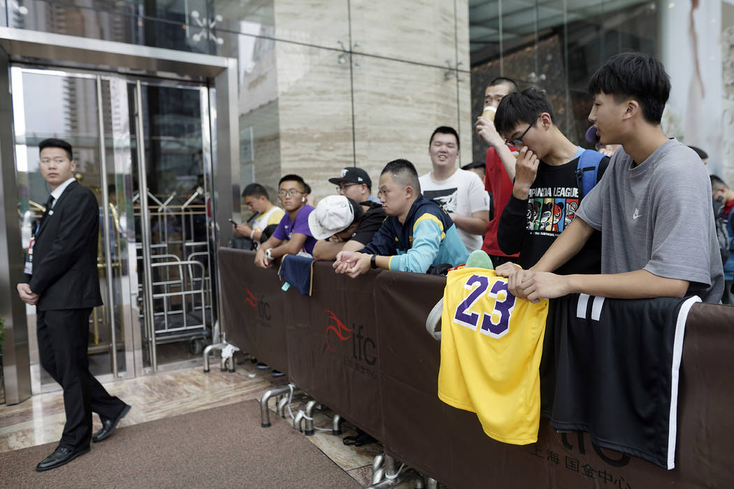 Chinese basketball fans gather outside of a hotel for a press conference that was later postpon ...