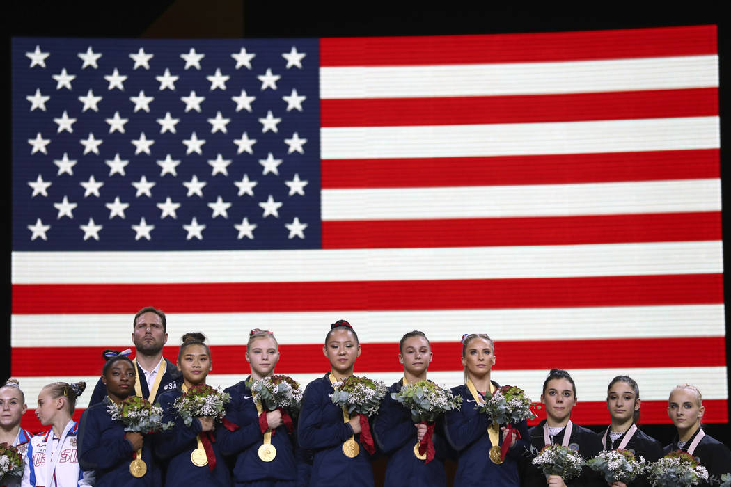 Team U.S.A. listens to the national anthem after winning the gold medal in the women's team fin ...