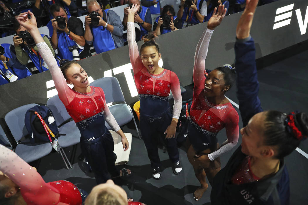 Team U.S.A. with Simone Biles, second right, celebrates winning the gold medal in the women's t ...