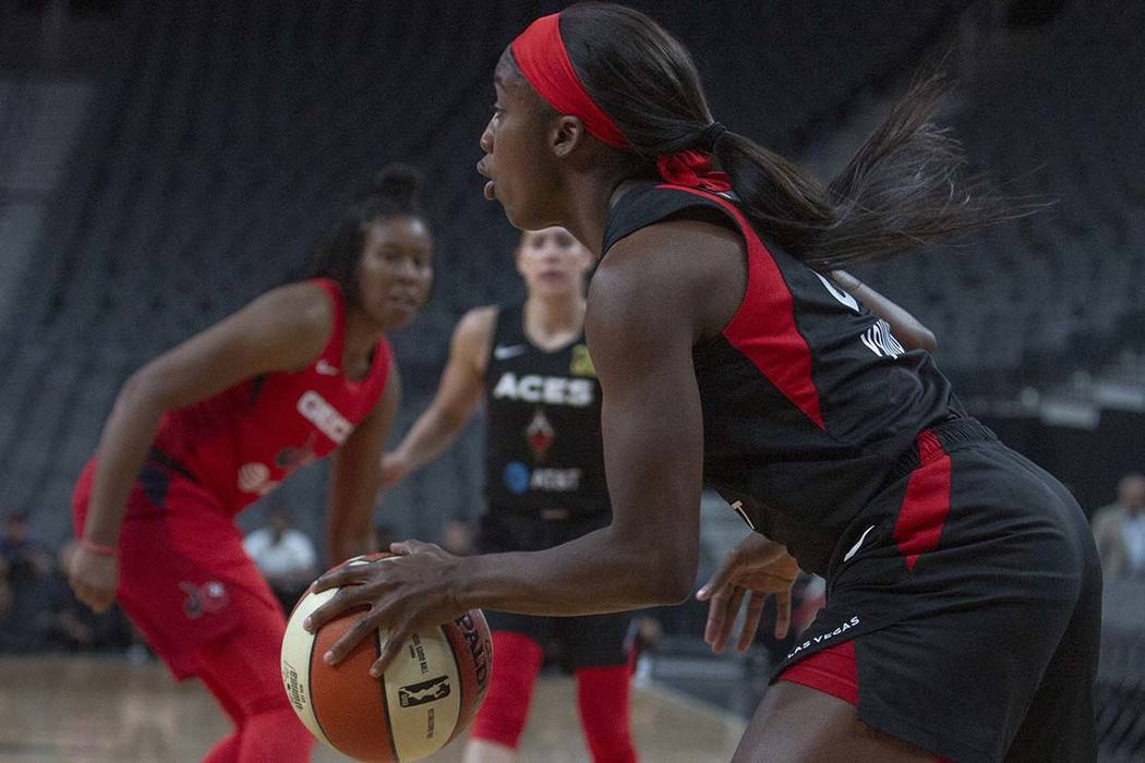 Las Vegas Aces guard Jackie Young (0) sets up a play against Washington Mystics players at T-Mo ...