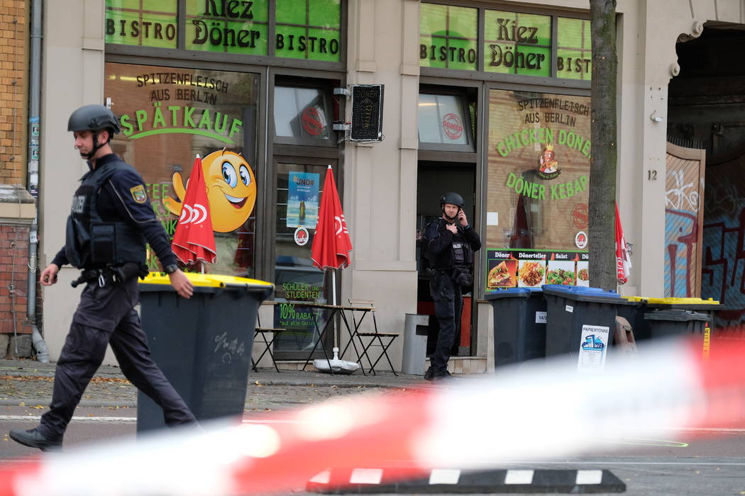 A police officer walks in front of a kebab grill in Halle, Germany, Wednesday, Oct. 9, 2019. A ...