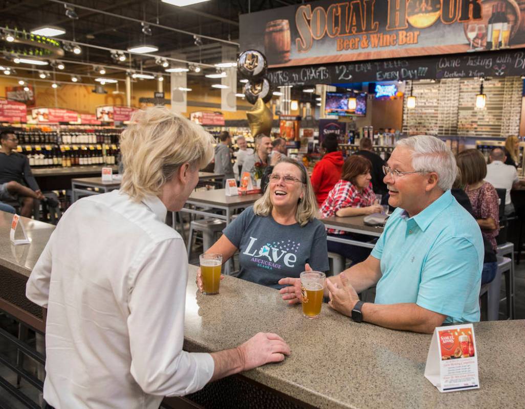 Wine steward Bradley Pugh, left, talks with Ron and Deb Crowl, from Anchorage, AK., at Social H ...