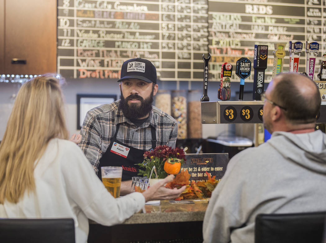 Bartender Adam Karli talks with patrons at Social Hour Beer and Wine Bar on Thursday, Oct. 10, ...