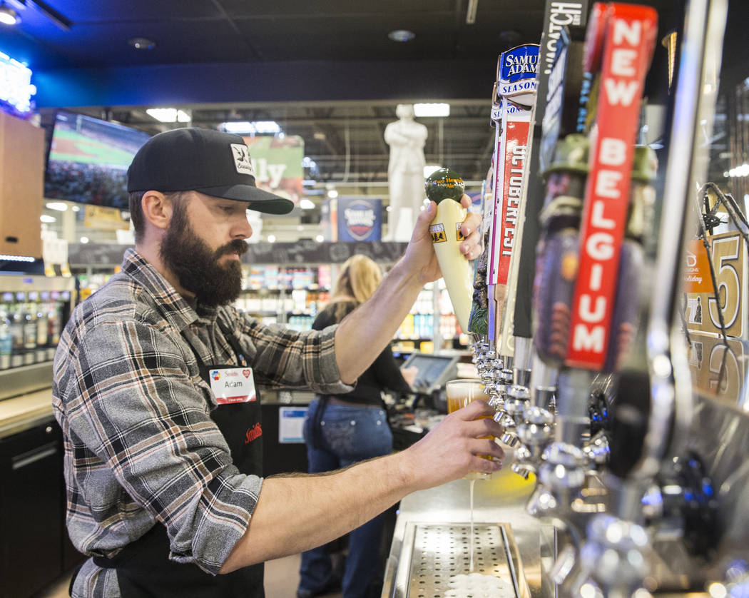 Bartender Adam Karli pours a beer at Social Hour Beer and Wine Bar on Thursday, Oct. 10, 2019, ...