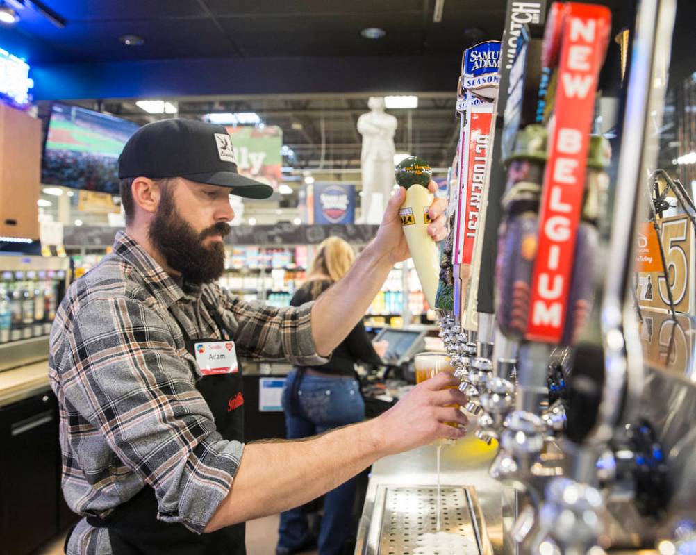 Bartender Adam Karli pours a beer at Social Hour Beer and Wine Bar on Thursday, Oct. 10, 2019, ...