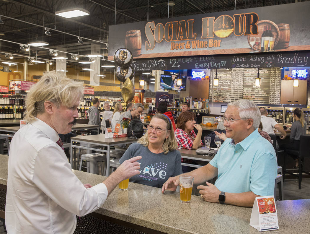 Wine steward Bradley Pugh, left, talks with Ron and Deb Crowl, from Anchorage, AK., at Social H ...