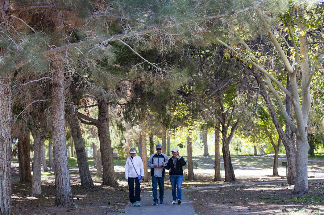 Jody Tomaszewski, from left, walks with her husband Ted Tomaszewski, and their friend Louis Etz ...