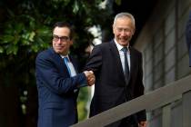 Chinese Vice Premier Liu He shake hands with Treasury Secretary Steven Mnuchin, as he arrives f ...