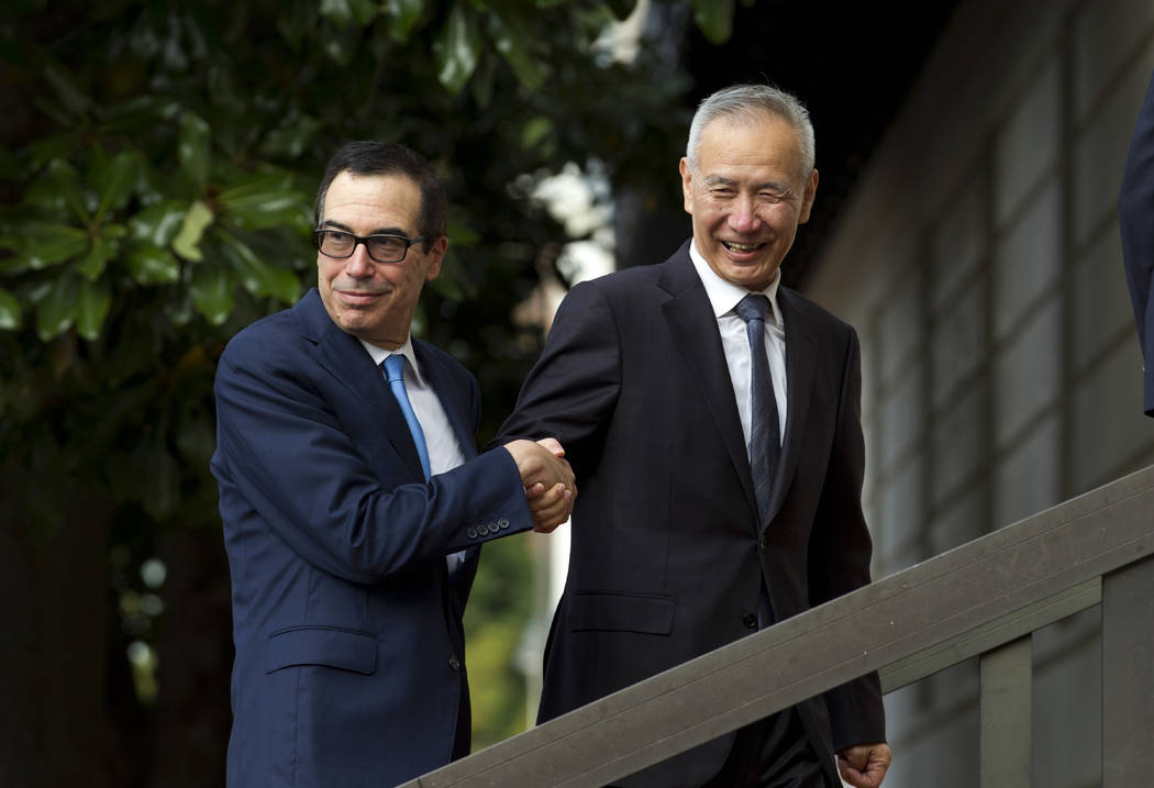 Chinese Vice Premier Liu He shake hands with Treasury Secretary Steven Mnuchin, as he arrives f ...