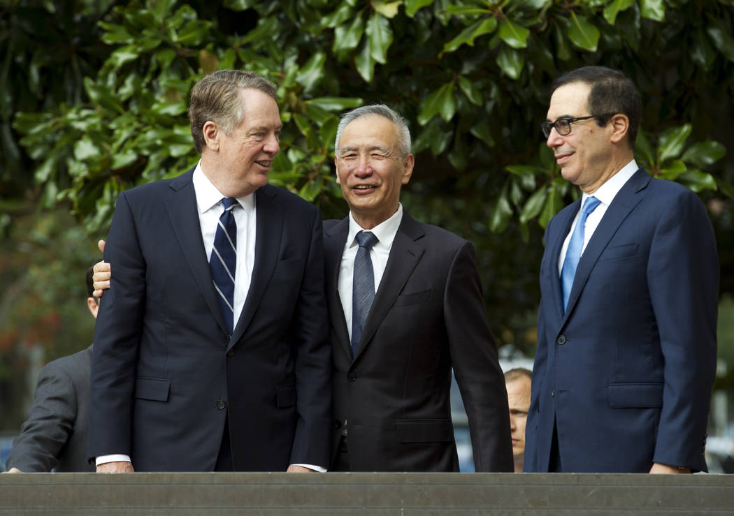 Chinese Vice Premier Liu He accompanied by U.S. Trade Representative Robert Lighthizer, left, a ...