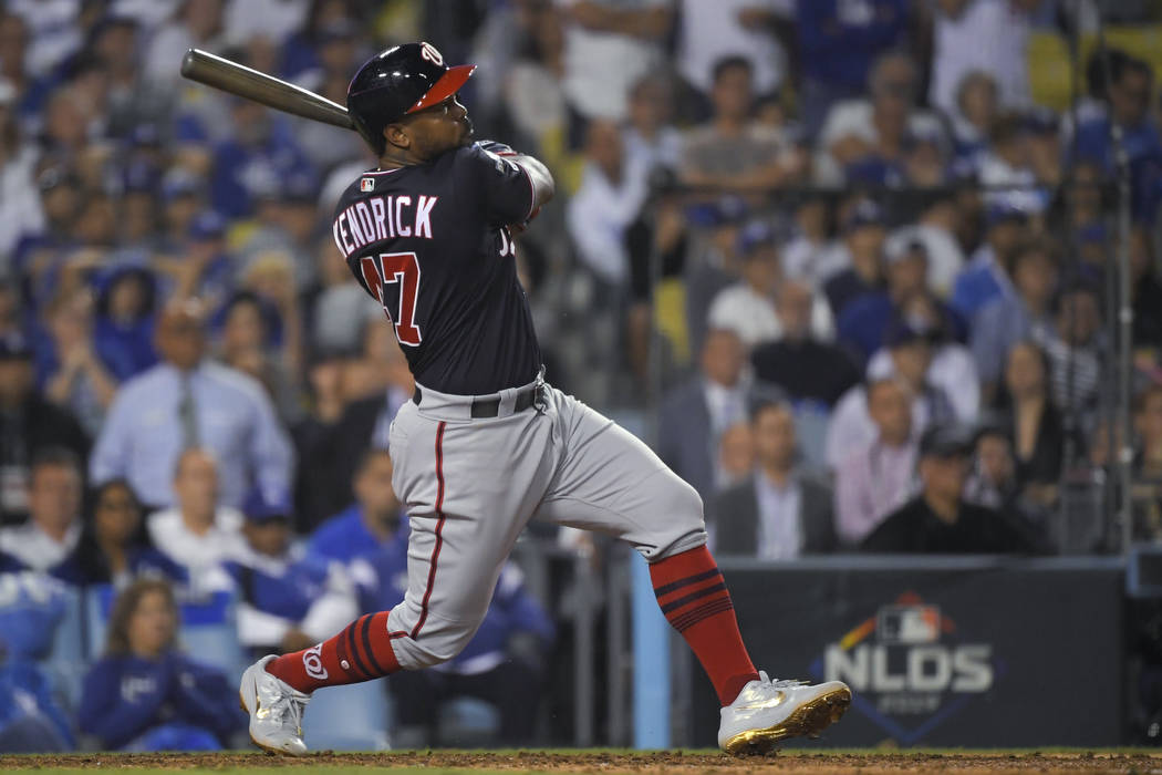 Washington Nationals' Howie Kendrick watches his grand slam against the Los Angeles Dodgers dur ...