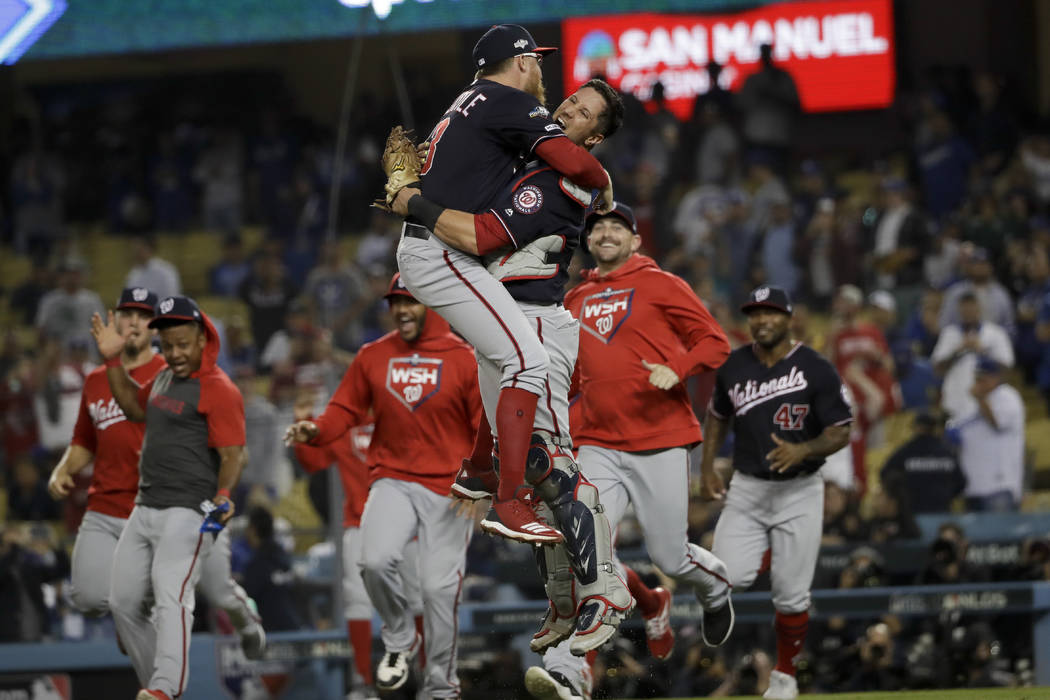 Washington Nationals pitcher Sean Doolittle, left, and catcher Yan Gomes leap in celebration af ...