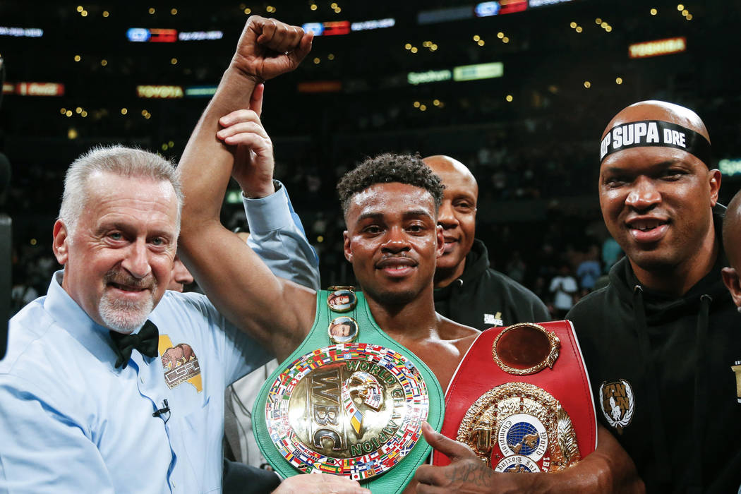 Errol Spence Jr., center, celebrates his victory over Shawn Porter during the WBC & IBF World W ...