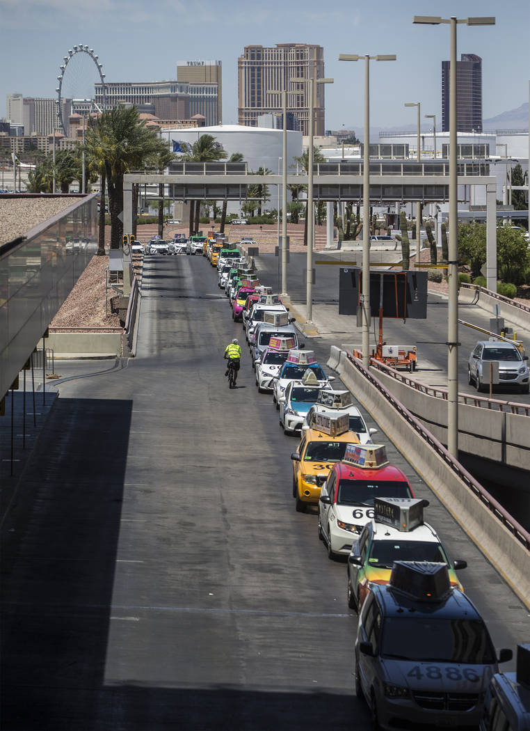 Taxis wait outside Terminal 1 at McCarran International Airport on Thursday, June 28, 2018, in ...