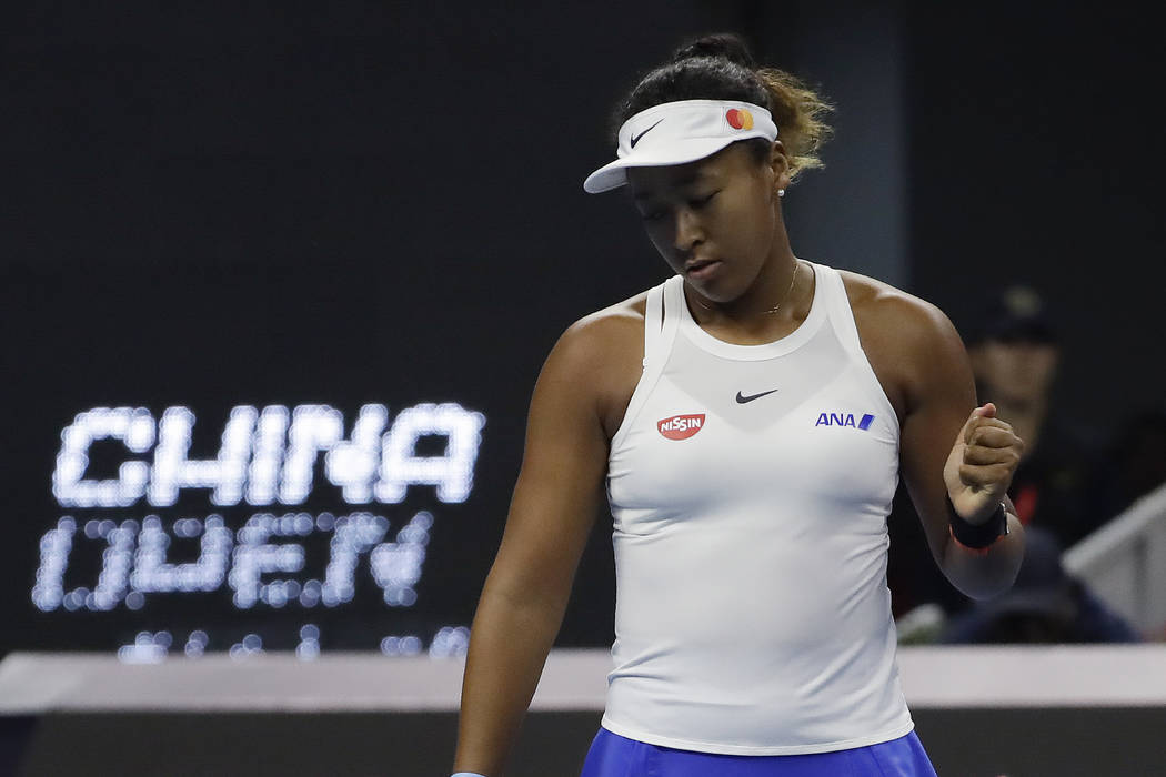 Naomi Osaka of Japan reacts while competing against Ashleigh Barty of Australia during their wo ...