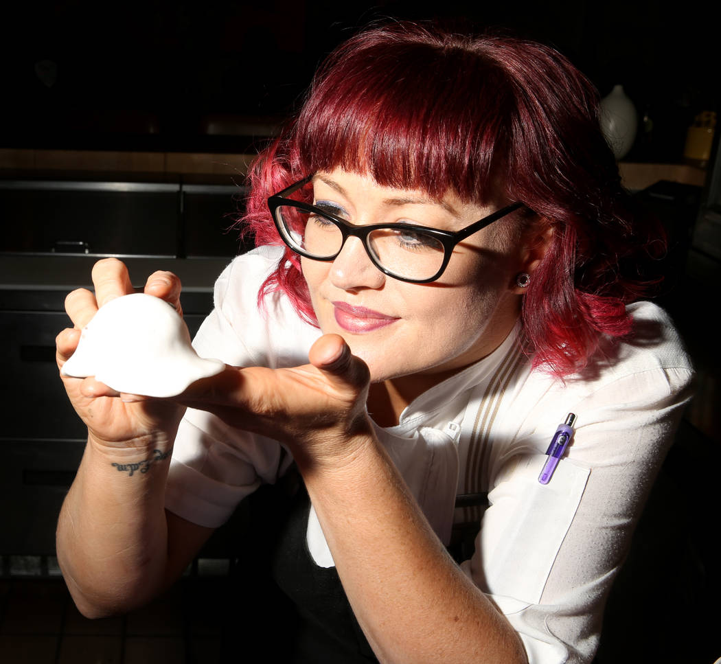 Pastry chef Sara Steele makes a Halloween ghost using fondant over a donut hole at Chica at The ...