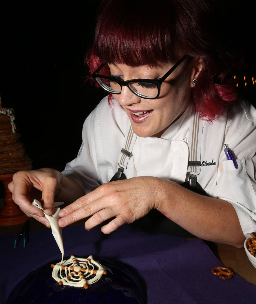 Pastry chef Sara Steele makes a Halloween spider web using pretzel sticks at Chica at The Venet ...