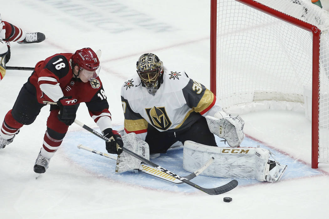 Arizona Coyotes left wing Christian Dvorak (18) has his shot blocked by Vegas Golden Knights go ...