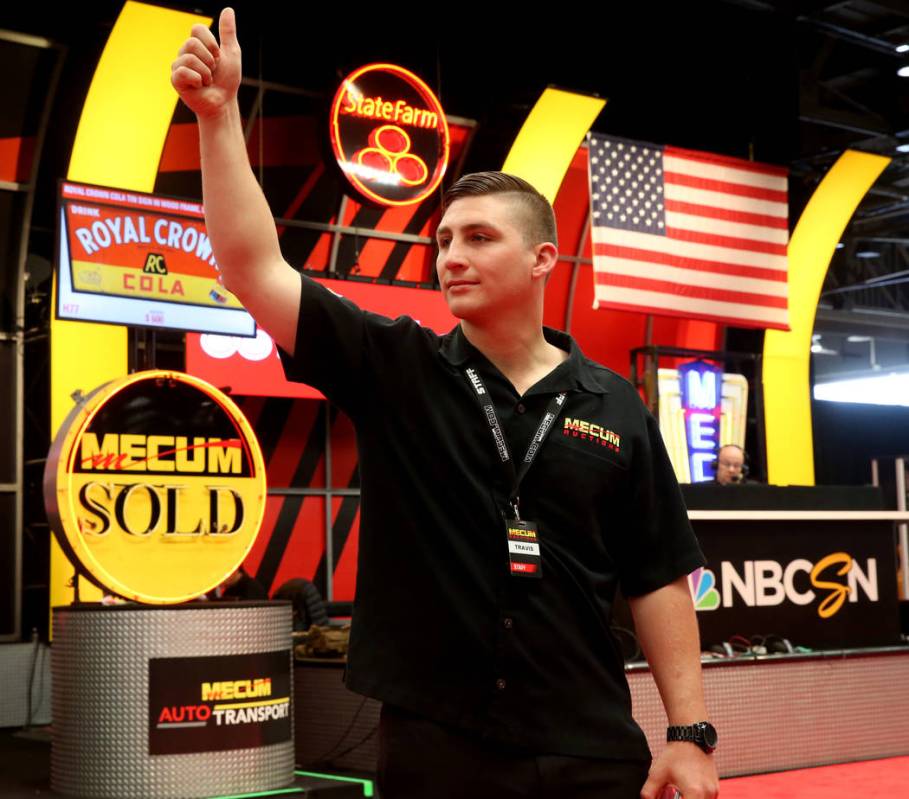 Ringman Travis Delzell signals during Mecum Las Vegas auction at the Las Vegas Convention Cente ...