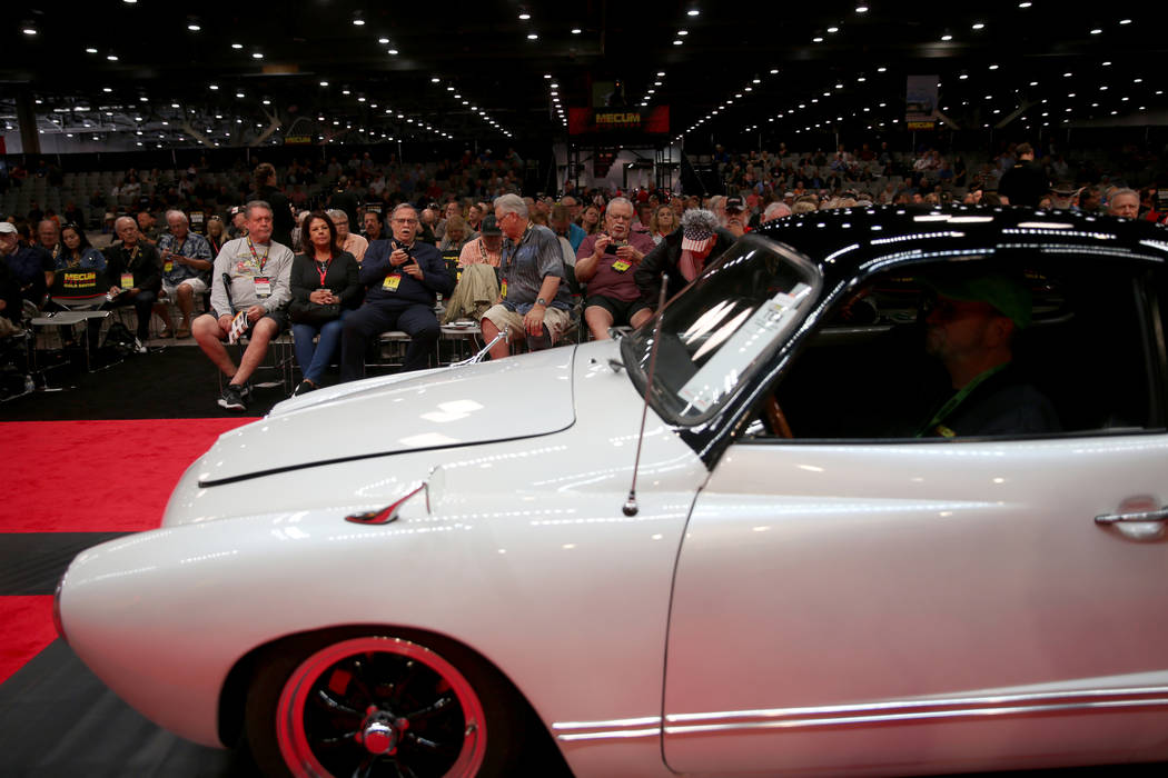 Bidders check out a 1972 Volkswagen Karmann Ghia on the auction block during Mecum Las Vegas au ...