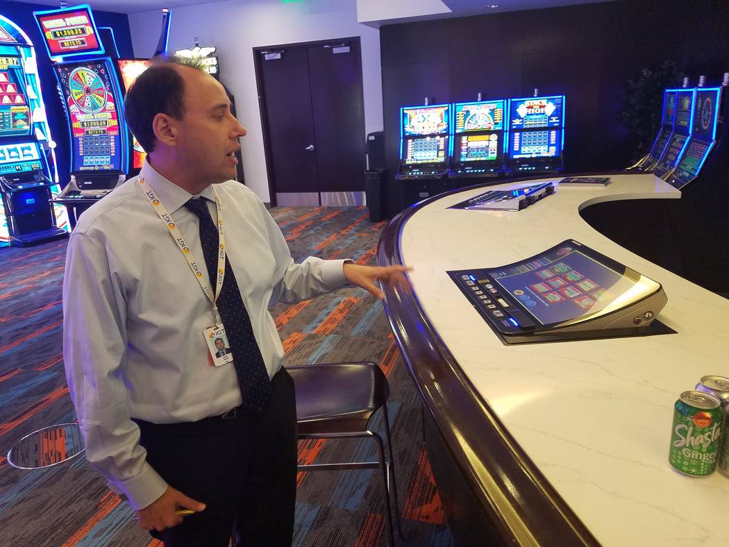 Nick Khin, chief commercial officer of gaming for IGT, shows off IGT's new curved-screen bartop ...