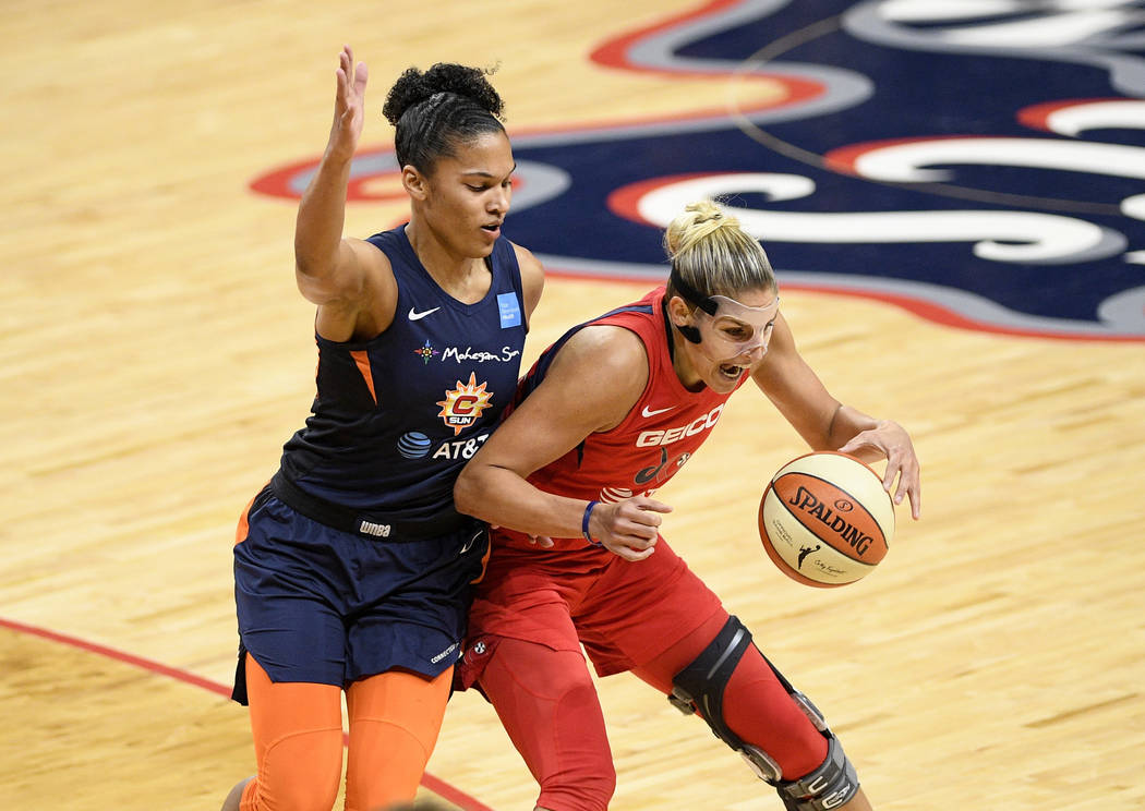 Washington Mystics forward Elena Delle Donne, right, dribbles the ball next to Connecticut Sun ...