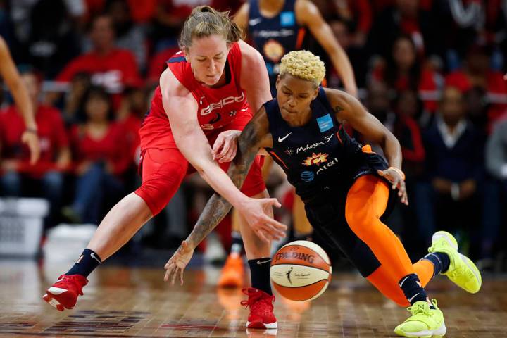 Washington Mystics center Emma Meesseman, left, and Connecticut Sun guard Courtney Williams go ...