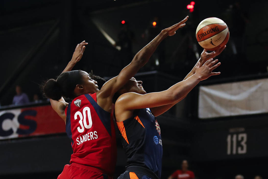 Connecticut Sun forward Alyssa Thomas, right, shoots past Washington Mystics forward LaToya San ...