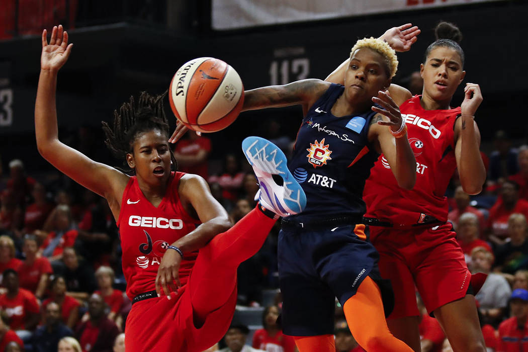 Washington Mystics guard Ariel Atkins, left, Connecticut Sun guard Courtney Williams and Washin ...