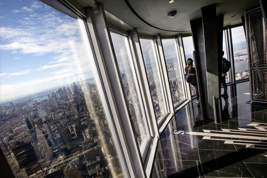 People look at the view from the 102nd floor observatory of the Empire State Building, in New Y ...