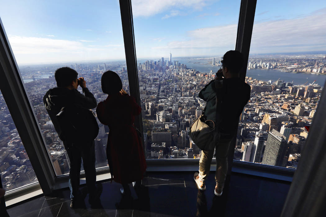 People look at the south view in the 102nd floor Observatory of the Empire State Building, in N ...