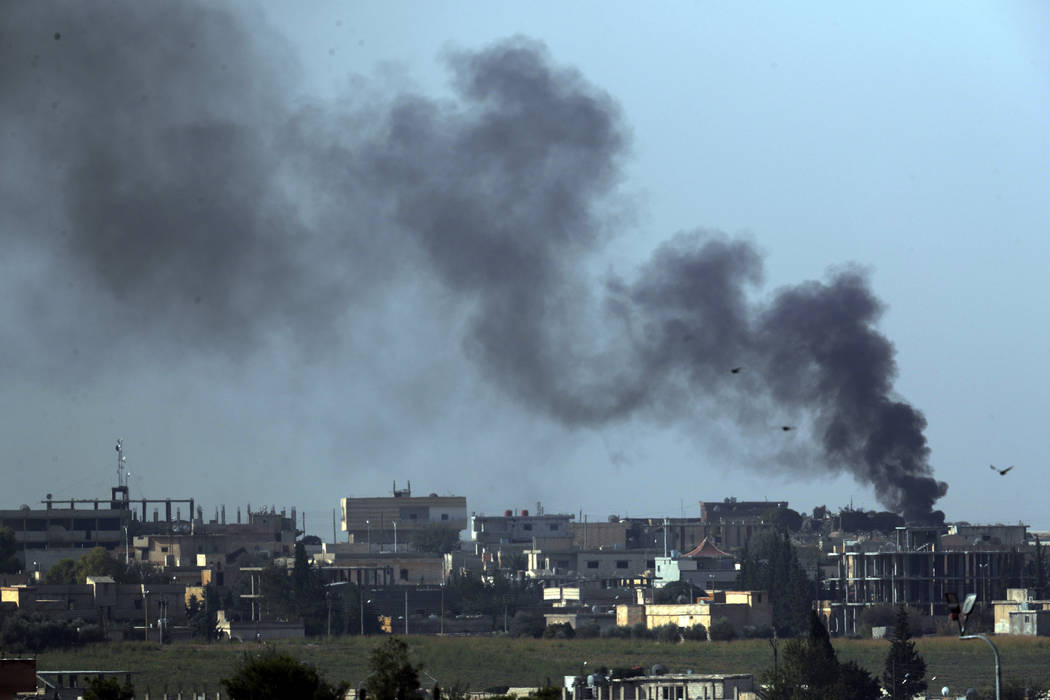 In this photo taken from the Turkish side of the border between Turkey and Syria, in Akcakale, ...