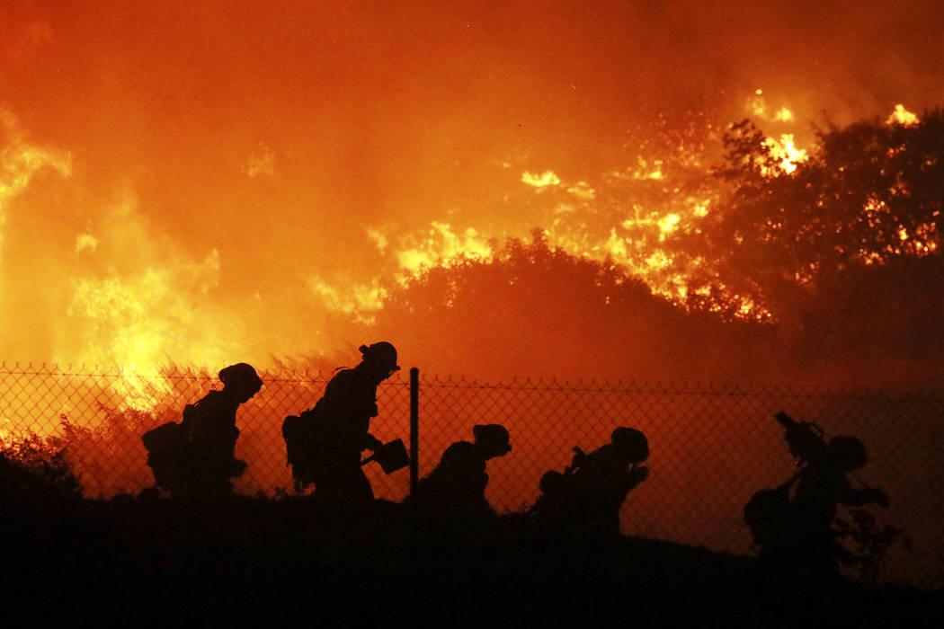 Firefighters battle the Saddleridge fire in Sylmar, Calif., Friday Oct. 11, 2019. (AP Photo/Dav ...