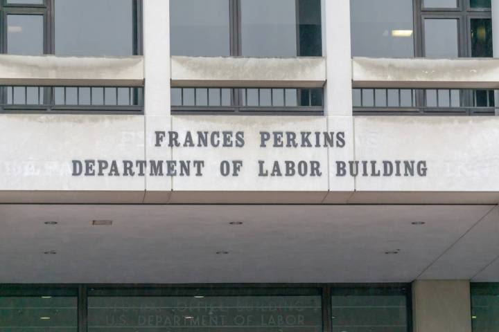 A photo of the sign on the front entrance of the Department of Labor building in Washington, D. ...