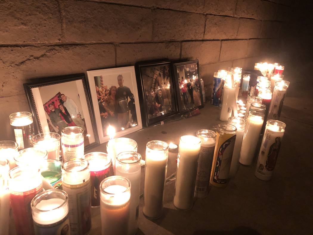 Pictures of 24-year-old Marco Antonio Alvizo are surrounded by religious candles on Friday, Oct ...