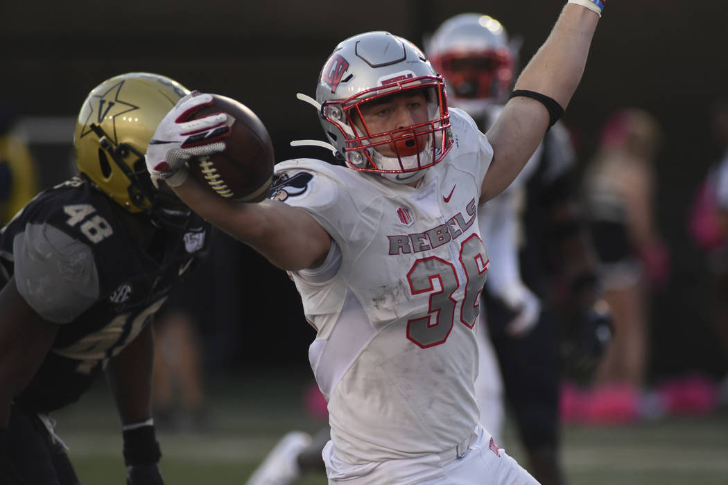 UNLV running back Chad Maygar, right, celebrates a touchdown past Vanderbilt linebacker Andre M ...