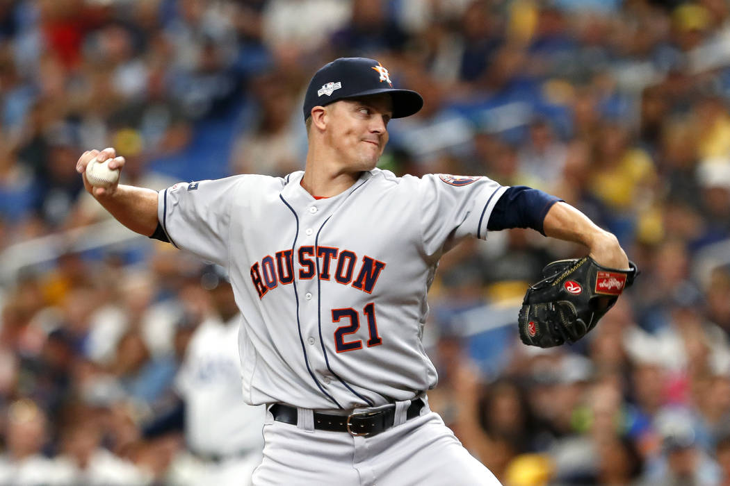 Houston Astros starting pitcher Zack Greinke throws during the first inning of Game 3 of a base ...