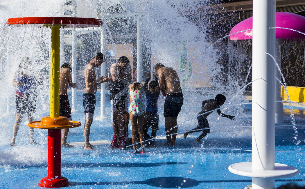 Hotel guests enjoy a water feature at the pool area at Circus Circus in Las Vegas on Friday, Ju ...