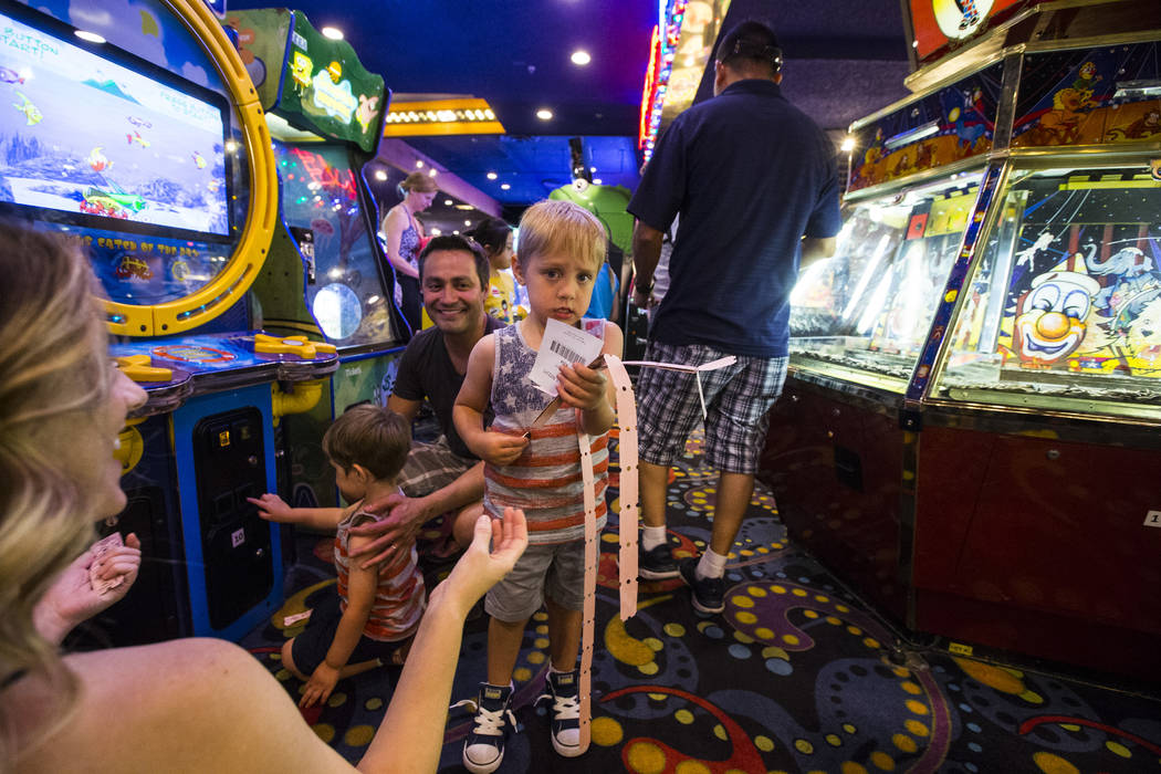 Four-year-old Emil Borrego holds his tickets as his mother Leslie Daniel, left, and father Reub ...