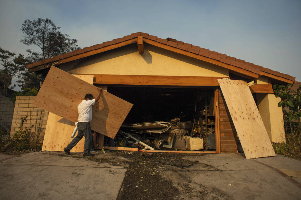Judy Webber has her Beaufait Avenue fire damaged home in the Porter Ranch area of Los Angeles b ...