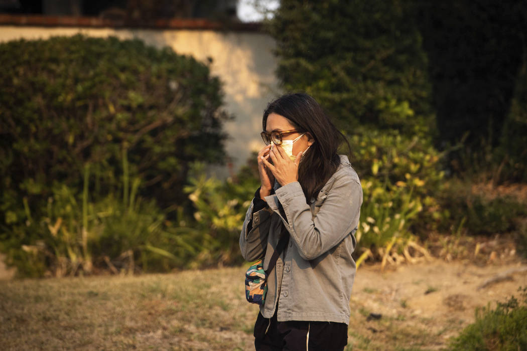 Sarah Sidharta walks along Beaufait Avenue in the Porter Ranch area of Los Angeles after the Sa ...