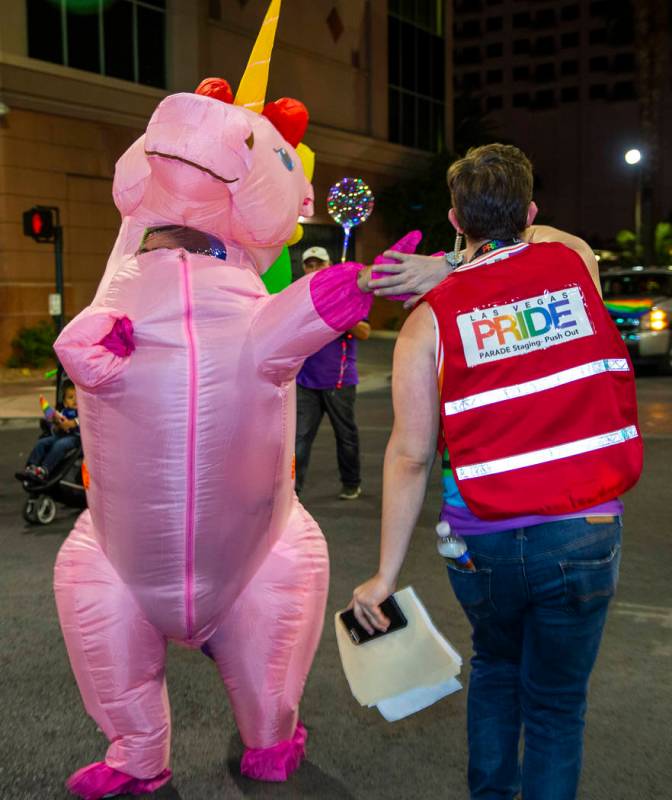 A marching pink unicorn gives a "high five" to an event coordinator during the annual Las Vegas ...